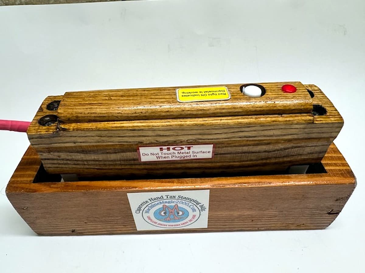 MM 10WD standard 2x5 ten stamp iron with wood handle resting in its wooden stand