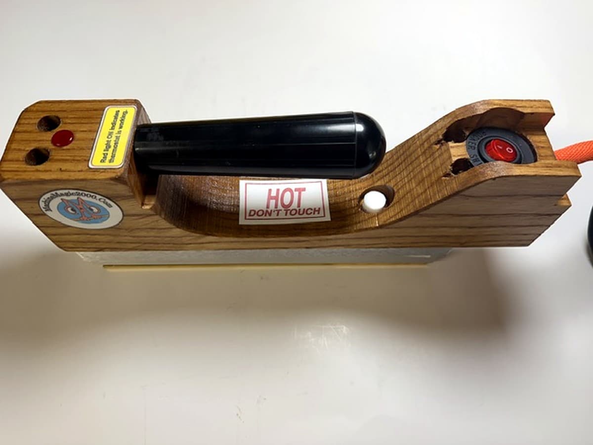MM 7DLXPLUS Deluxe Plus solid bar iron showing its rear illuminated on/off power switch
