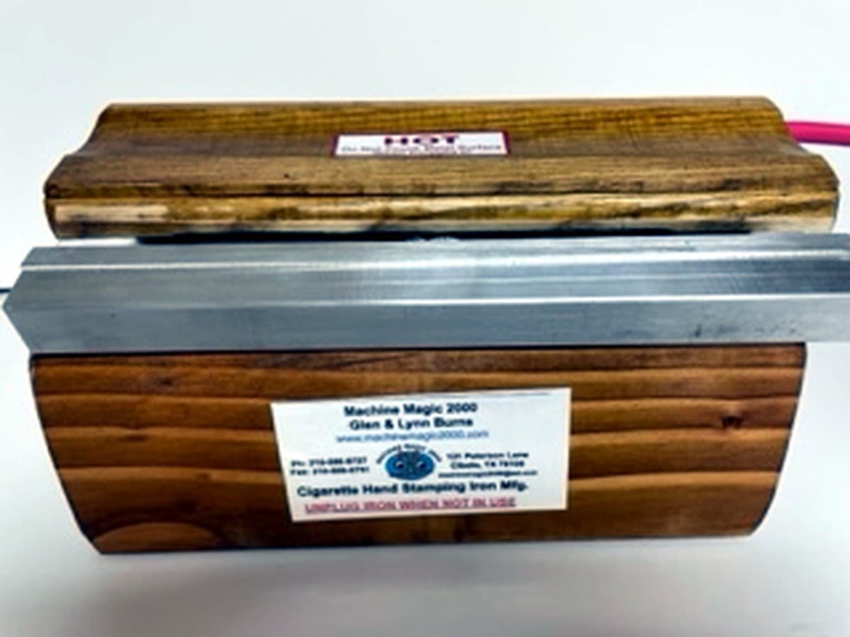 MM 7WH standard solid bar iron with wood handle resting in its wooden stand