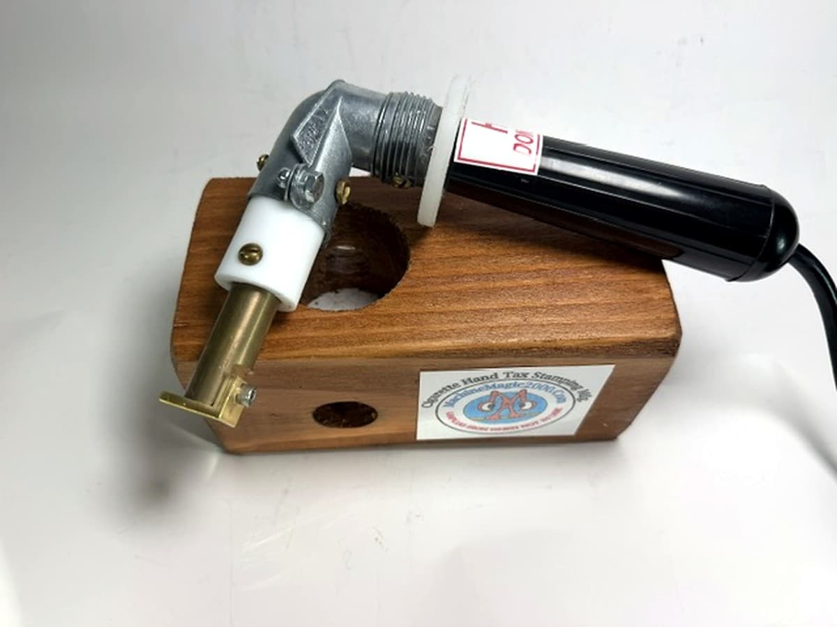 MM 8 single stamp iron with black handle beside its wooden stand